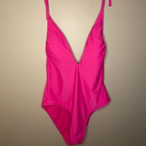 A bright pink one piece bathing suit